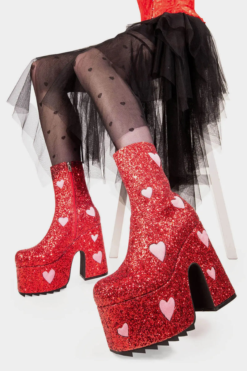 Fairy Dust
  
  Keeper Chunky Platform Ankle Creeper Boot in Red Glitter. These red vegan Platform Boots feature our iconic glitter detail throughout with pink suede hearts, leave a trail of sparkle and make every step a dazzling statment Made with eco-friendly materials and 100% cruelty-free.
  
  
  - Platform Height
  - Heel Height 
  - Red zipper 
  - Pink suede hearts 
  - Chunky Creeper sole
  - Shark's teeth grip
  - Round Toe
  - 100% vegan 
  
  SKU: LMF 2047 - RedGlitter/PinkHeart