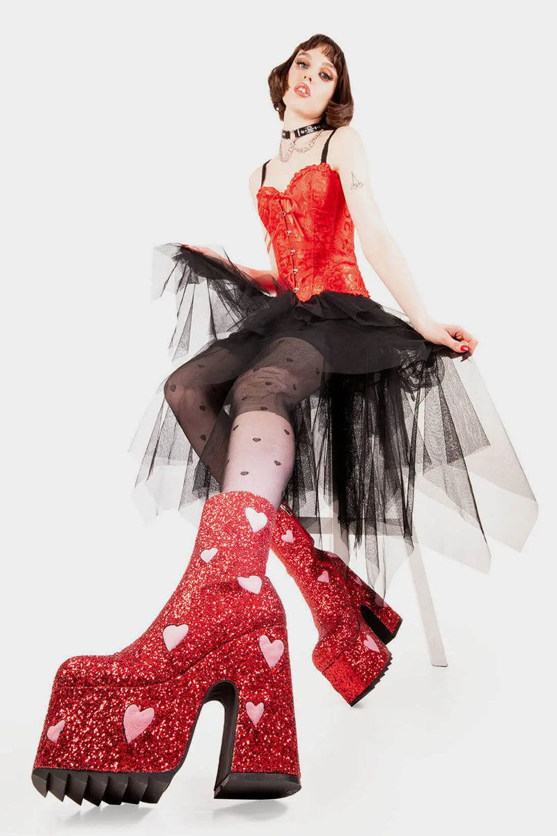Fairy Dust
  
  Keeper Chunky Platform Ankle Creeper Boot in Red Glitter. These red vegan Platform Boots feature our iconic glitter detail throughout with pink suede hearts, leave a trail of sparkle and make every step a dazzling statment Made with eco-friendly materials and 100% cruelty-free.
  
  
  - Platform Height
  - Heel Height 
  - Red zipper 
  - Pink suede hearts 
  - Chunky Creeper sole
  - Shark's teeth grip
  - Round Toe
  - 100% vegan 
  
  SKU: LMF 2047 - RedGlitter/PinkHeart