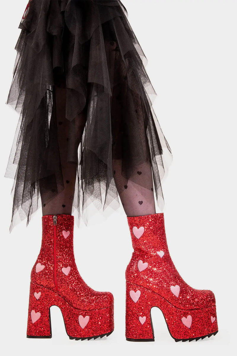 Fairy Dust
  
  Keeper Chunky Platform Ankle Creeper Boot in Red Glitter. These red vegan Platform Boots feature our iconic glitter detail throughout with pink suede hearts, leave a trail of sparkle and make every step a dazzling statment Made with eco-friendly materials and 100% cruelty-free.
  
  
  - Platform Height
  - Heel Height 
  - Red zipper 
  - Pink suede hearts 
  - Chunky Creeper sole
  - Shark's teeth grip
  - Round Toe
  - 100% vegan 
  
  SKU: LMF 2047 - RedGlitter/PinkHeart