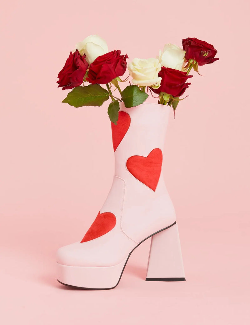 LOVEY DOVEY 
  
  Letter To My Lover Platform Ankle Boots in Pink faux leather. These platform boots feature a pink boot with big red heart all over. Made with eco-friendly materials and 100% cruelty-free, these platform boots are as ethical as they are chic.
  
  - Platform Height
  - Big red hearts
  - Calf length
  - Triangle heel
  - High Heel
  - 100% vegan 
  
  SKU: LMF 3337 - PinkPU/RedHeart