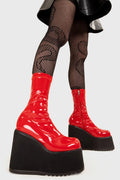 Platform Staples
  
  Lights Out Chunky Platform Ankle Boots in Red Patent faux leather. These red platform boots feature on our chunky platform wedge sole, step up your shoes game! Made with eco-friendly materials and 100% cruelty-free, these platform boots are as ethical as they are Fashion Staples!
  
  - Platform Height
  - Red Zip
  - Chunky Platform wege sole
  - Shark's teeth rubber grip
  - Round Toe 
  - 100% vegan 
  
  SKU: LMF 2369 - RedPAT