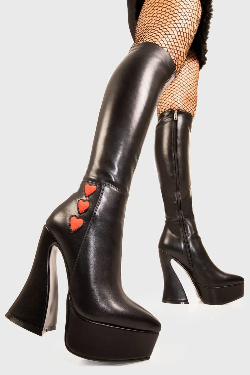 Lovestruk

Love Potion Platform Knee High Boots in Black faux leather. These black vegan Platform Boots feature three red suede hearts on the outter on our platform sole, elevating your style with love. Made with eco-friendly materials and 100% cruelty-free, these platform boots are as ethical as they are heart warming!


- Platform Height: 1.4 inch
- Heel Height: 5 inch
- Flared heel
- Black zipper 
- Red suede hearts 
- Chunky Platform sole
- Round Toe
- 100% vegan 

SKU: LMF 1900 - BlackPU/RedHeart - UK3