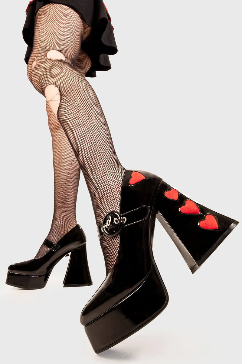 Cupid is here 
  
  Love Sick Platform Heels in Black Patent faux leather. These vegan Platform Heels feature pink patent hearts on the heel and side of the shoe with a adjustable black strap, Heels that speak the language of love. 
  
  - Platform Height: 2.6 inch
  - Heel Height: 5.5 inch
  - Ajustable strap 
  - "O" ring shaped buckles and silver eyelets
  - Pink Patent hearts 
  - Platform sole
  - Flared heel
  - Round toe 
  - 100% vegan
  
  SKU: LMF 1709 - BlackPAT/RedHeart