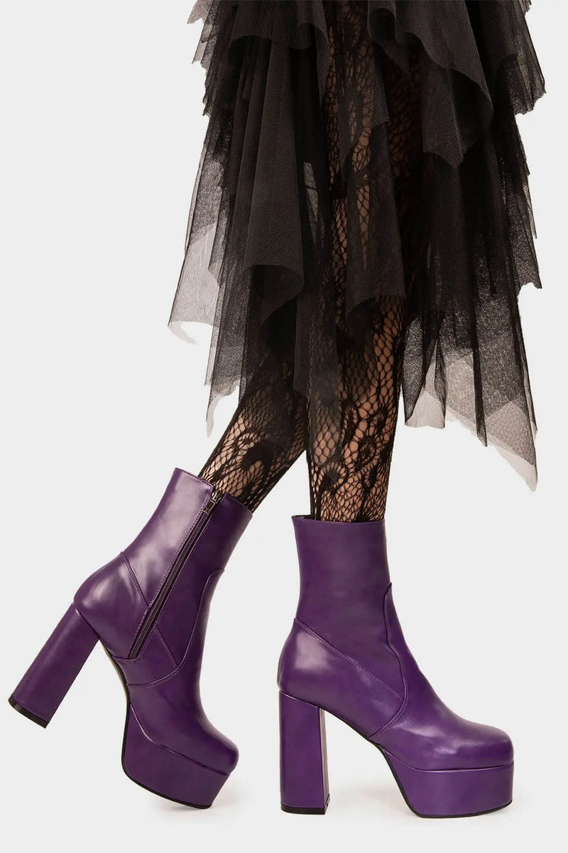Diva's Delight.
  
  Making Moves Platform Ankle Boots in Purple faux leather. These vegan Platform Ankle boots feature a platform sole to reach new heights in the style game. Made with eco-friendly materials and 100% cruelty-free, these Boots are as ethical as they are delightful!
  
  - Platform Height: 1.25 inch
  - Heel Height: 4.2 inch
  - Purple Zipper
  - High Platform sole
  - Round toe
  - 100% vegan
  
  SKU: LMF 1559 - PurplePU