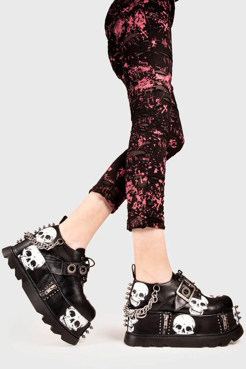 Rebel Soles.

Maniac Chunky Platform Wedge Shoes in Black faux leather. These Black vegan platform shoes feature our ICONIC Skull print on a chunky platform sole , leaving a mark and making a statment. Made with eco-friendly materials and 100% cruelty-free, these boots are as ethical as they are badass!


- Platform Height: 3.2 inch
- Adjustable strap with silver eyelets
- Black laces 
- Skull print
- Silver spikes
- Silver Chain
- Platform wedge sole
- Round Toe
- 100% vegan 

SKU: LMF 1541 - BlackPU/Skull