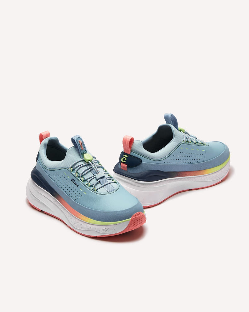 Pair of blue running shoes with colorful accents on a white background