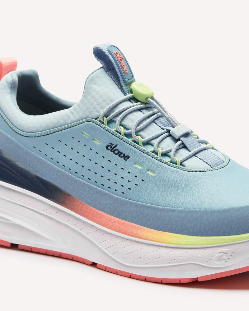Light blue running shoe with colorful sole on a white background