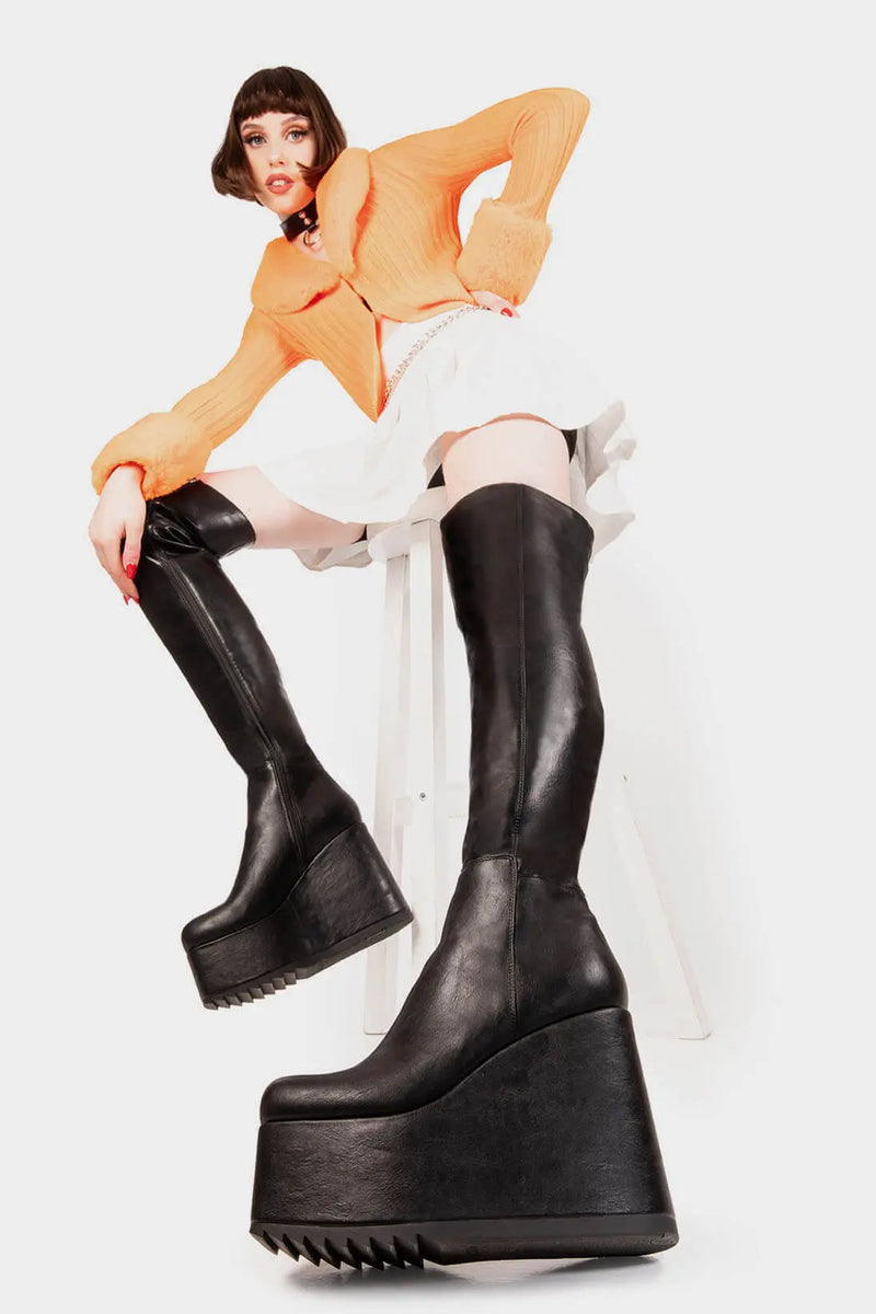 Peak Perfection
  
  Never Again Chunky Platform Thigh High Boot in Black faux leather. These black vegan Platform Boots feature on our chunky platform wedge sole, let the boots do the talking. Made with eco-friendly materials and 100% cruelty-free, these platform boots are as ethical as they are Perfect!
  
  
  - Platform Height
  - Black Zipper
  - Chunky Platform wedge sole
  - Shark's teeth grip
  - Round Toe
  - 100% vegan 
  
  SKU: LMF 2069 - BlackPU