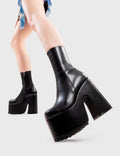 Not Your Basic Boots
  
  Night Train Chunky Platform Ankle Boots in Black faux leather. These platform boots feature an elegant, minimalist design, perfect for elevating any outfit. Made with eco-friendly materials and 100% cruelty-free, these platform boots are as ethical as they are cool.
  
  - Platform Height
  - Heel Height
  - Black Zip
  - Shark's teeth grip
  - Chunky Platform sole
  - 100% vegan 
  
  SKU: