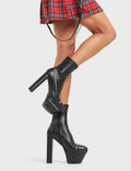 VIGILANTE
  
  No Chance Platform Ankle Boots in Black faux leather. These boots feature an edgy zip design around the boot, with a block heel that also features a zip design. On our platform sole with shark's teeth rubber grip, the perfect way to make everyone stop and stare. Made with eco-friendly materials and 100% cruelty-free.
  
  - Platform Height: 5.5 CM
  - Heel Height: 14 CM
  - Silver Zip design
  - High Heel
  - Platform sole
  - Round toe.
  - 100% vegan
  
  SKU: LMF 4424 - BlackPU