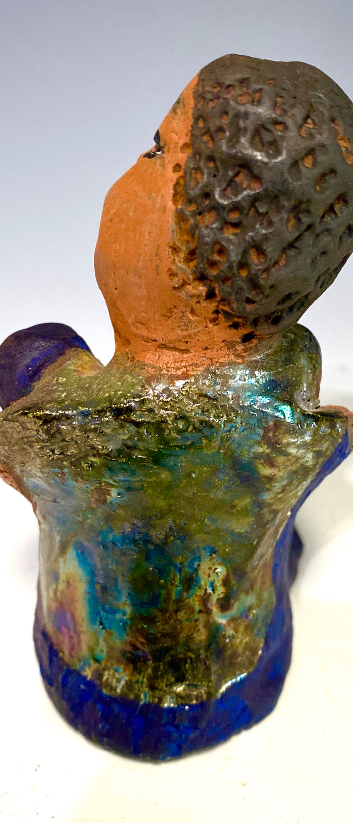 Paul is a Handsome Mischief Guy!  Do you see the wit in his face?  Paul stands 4.5"x 3" x 3" and weighs 6.9 ozs. He has a shimmery metallic tee shirt. Paul's complexion is honey brown. His arms are folded around his legs as he ponders another mischief moment!