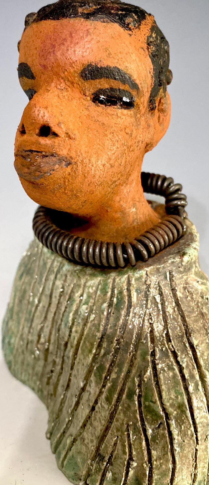 "It is obvious Herdew implies that most of my sculptures are female. My goal this year is to create ten male sculptures. Alvin is one of the first that I am pleased with. Pete stands 5" x 4" x 3" and weighs 10 ozs. He wears an etched metallic multi colored jacket with a cioled wire necklace. Pete has a honey brown complexion. Pete seems to be in deep thought about ﻿﻿his next move in life. Pete  would display proudly in your home.