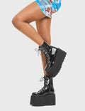 ELEVATED 
  
  Renegade Chunky Platform Ankle Boots in Black patent. These vegan western Boots feature silver eyelets and a shark teeth grip sole, very edgy. Made with eco-friendly materials and 100% cruelty-free, these boots are as ethical as they are Chic!
  
  
  - Chunky Platform
  - Ankle length
  - Shark teeth grip
  - Black Laces
  - Rounded toe 
  - 100% vegan 
  
  SKU: LMF 3746 - BlackPAT