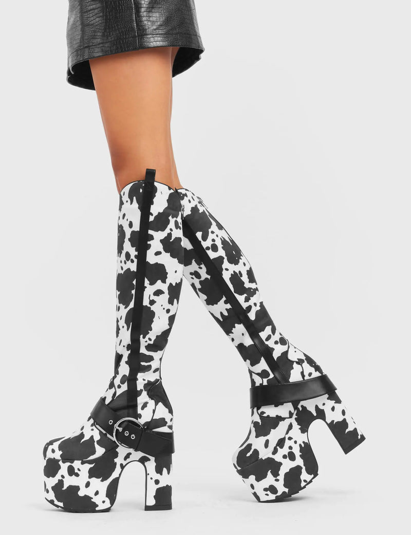 ANIMALISTIC
 
 Rhinestone Cowboy Chunky Platform Knee High Boots in Cow Print faux suede. These vegan Platform Boots feature an ICONIC western cow print on a Chunky Platform sole and heel, also features a adjustable strap across the front. Made with eco-friendly materials and 100% cruelty-free, these boots are as ethical as they are wild!
 
 
 - Platform Height: 
 - Heel Height: 
 - Cowprint Design
 - Knee High Length 
 - Black Zipper
 - Platform Sole
 - Pointed Toe
 - 100% vegan
 
 SKU: LMF 5118 - Cowprint