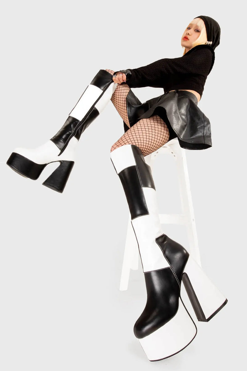 TIME TO DANCE
  
  Runway Platform Knee High Boots in Black and white faux leather. These platform boots feature a black and white patch work design with a triangle heel, keeping it nice and classy. Made with eco-friendly materials and 100% cruelty-free, these platform boots are as ethical as they are chic.
  
  - Platform Height
  - Knee high length
  - Patch work design
  - Triangle heel
  - High Heel
  - 100% vegan 
  
  SKU: LMF 3361 - BlackPU/WhitePU