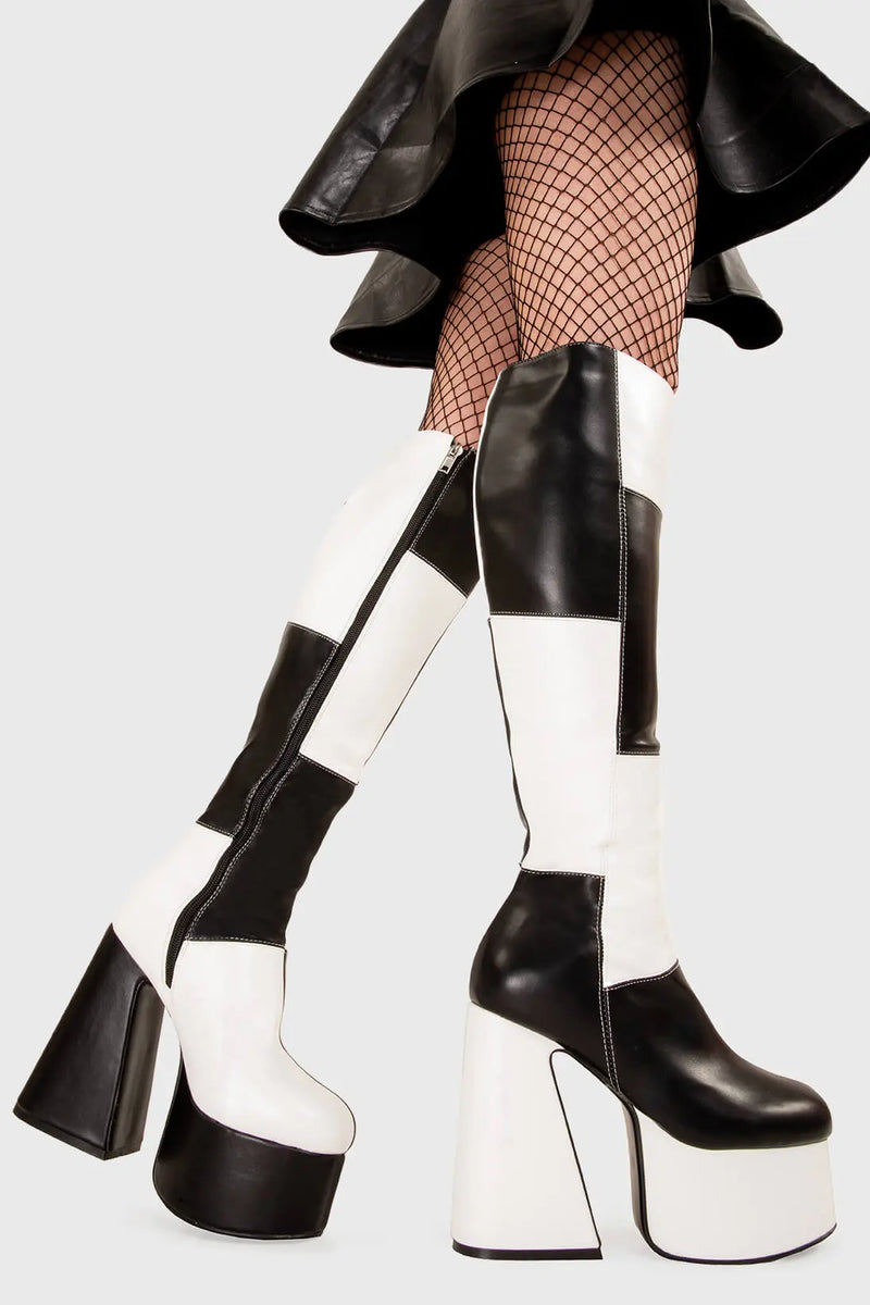 TIME TO DANCE
  
  Runway Platform Knee High Boots in Black and white faux leather. These platform boots feature a black and white patch work design with a triangle heel, keeping it nice and classy. Made with eco-friendly materials and 100% cruelty-free, these platform boots are as ethical as they are chic.
  
  - Platform Height
  - Knee high length
  - Patch work design
  - Triangle heel
  - High Heel
  - 100% vegan 
  
  SKU: LMF 3361 - BlackPU/WhitePU
