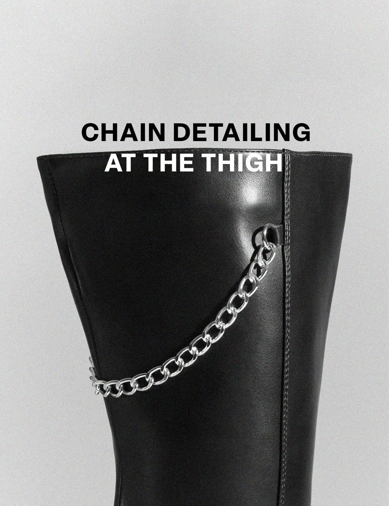 HERE AND NOW
  
  Scream Wide Calf Platform Thigh High Boots in Black faux leather. These vegan Boots feature Silver buckles, chains and spikes, making them the perfect comfy Boots. Made with eco-friendly materials and 100% cruelty-free, these boots are as ethical as they are comfy!
  
  
  - Thigh High length 
  - Silver spikes
  - Silver chains
  - Silver buckles
  - Skull face
  - Cunky Platform sole
  - Round toe 
  - 100% vegan 
  
  SKU: LMF 0988 - BlackPU - WIDE FIT
