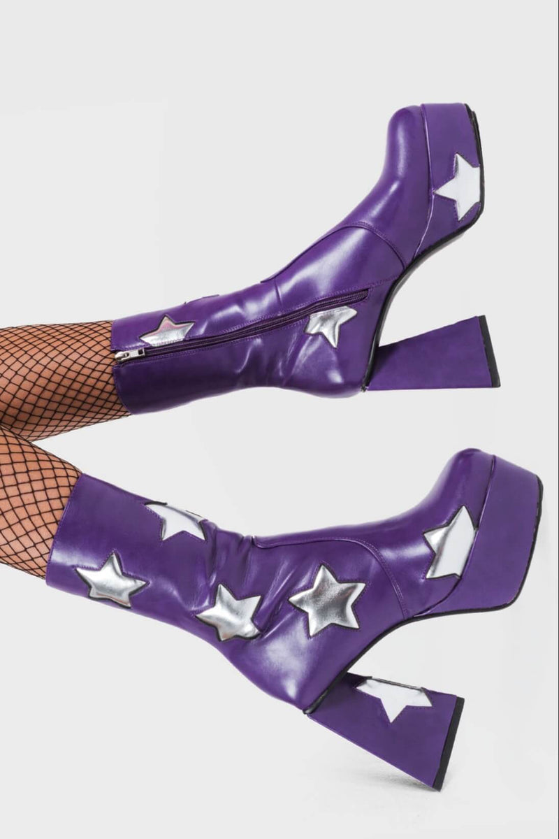 DISCO FEVER 
  
  Seeking Stars Platform Ankle Boots in Purple faux leather. These platform boots feature a purple boot with silver stars all over. Made with eco-friendly materials and 100% cruelty-free, these platform boots are as ethical as they are chic.
  
  - Platform Height
  - Silver stars
  - Calf length
  - Triangle heel
  - High Heel
  - 100% vegan 
  
  SKU: LMF 3338 - PurplePU/SilverStar