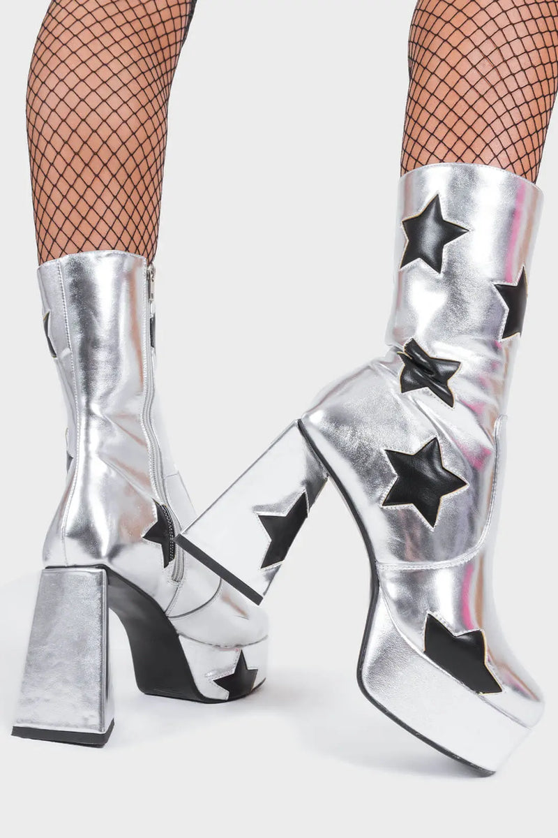 DISCO FEVER 
  
  Seeking Stars Platform Ankle Boots in silver faux leather. These platform boots feature a silver boot with black stars all over. Made with eco-friendly materials and 100% cruelty-free, these platform boots are as ethical as they are chic.
  
  - Platform Height
  - Black stars
  - Calf length
  - Triangle heel
  - High Heel
  - 100% vegan 
  
  SKU: LMF 3338 - SilverPU/BlackStar