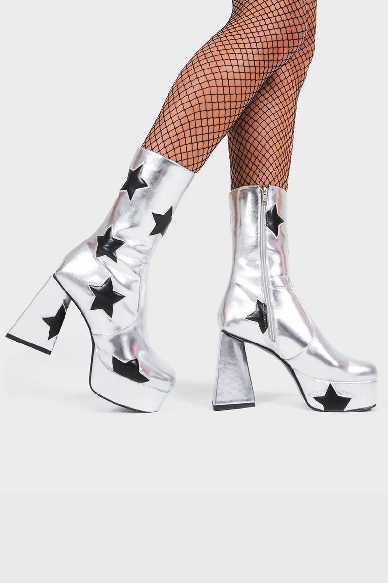 DISCO FEVER 
  
  Seeking Stars Platform Ankle Boots in silver faux leather. These platform boots feature a silver boot with black stars all over. Made with eco-friendly materials and 100% cruelty-free, these platform boots are as ethical as they are chic.
  
  - Platform Height
  - Black stars
  - Calf length
  - Triangle heel
  - High Heel
  - 100% vegan 
  
  SKU: LMF 3338 - SilverPU/BlackStar