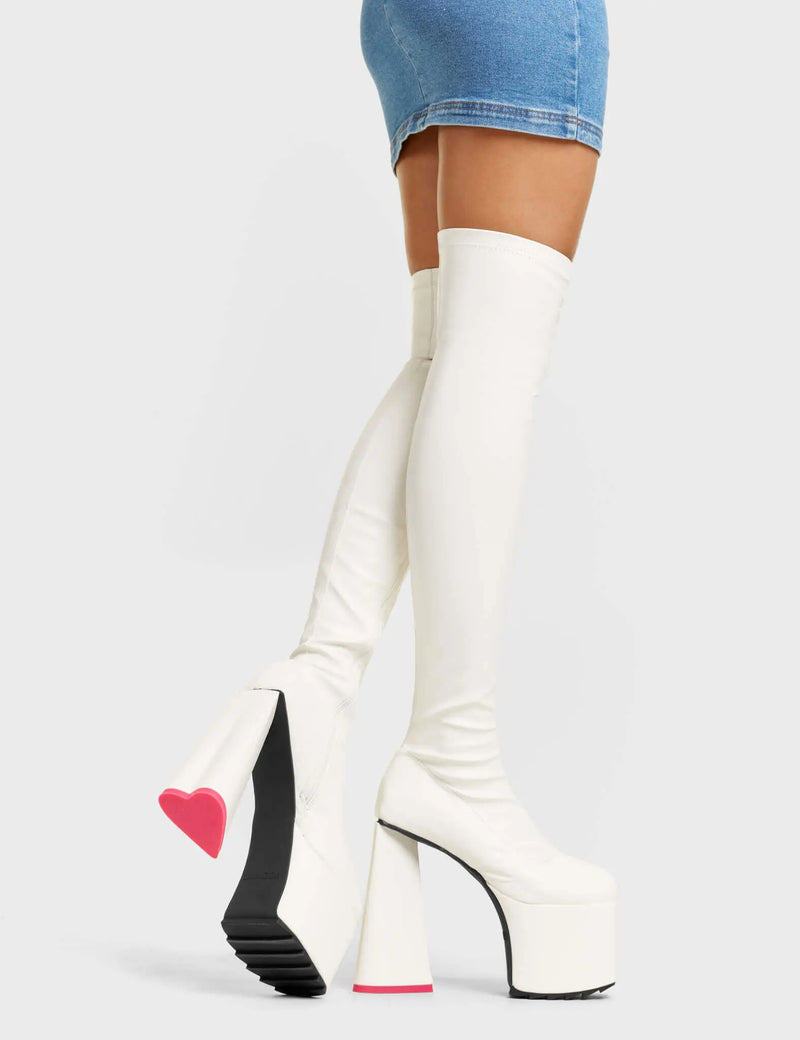 DON"T LEAVE
 
 Separate Platform Thigh High Boots in White faux leather. These white vegan Platform Boots feature a stretch design on our platform sole which has a heart shaped heel and a red heart at the bottom. Made with eco-friendly materials and 100% cruelty-free, these platform boots are as ethical as they are dominant!
 
 
 - Platform Height:
 - Fuchsia Zipper
 - Shark's Teeth Rubber Grip
 - Platform Sole
 - Red Heart Detail
 - Square Toe
 - 100% vegan
 
 SKU: LMF 4909 - FuchsiaPU