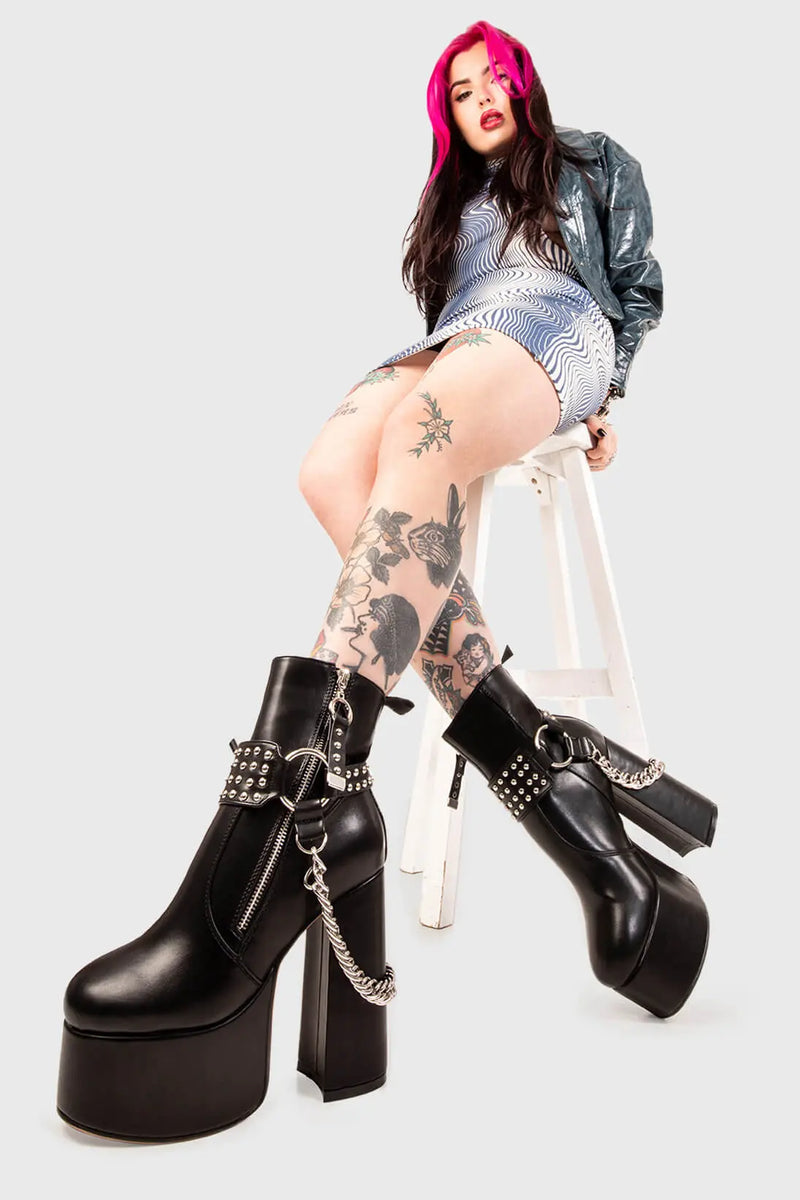 BIKER GAL

So What Platform Ankle Boots in Black faux leather. These Platform Boots feature removable saddle with silver studs and a haning chain, making them the perfect choice to elevate your look! Made with eco-friendly materials and 100% cruelty-free, these boots are as ethical as they are wild!


- Platform Height: 2.5 inch
- Heel Height: 5.5 inch 
- Mid ankle length 
- Silver zipper
- Removable saddle
- Silver chain and studs
- High Platform sole
- Round toe 
- 100% vegan 

SKU: LMF 0150 - BlackPU