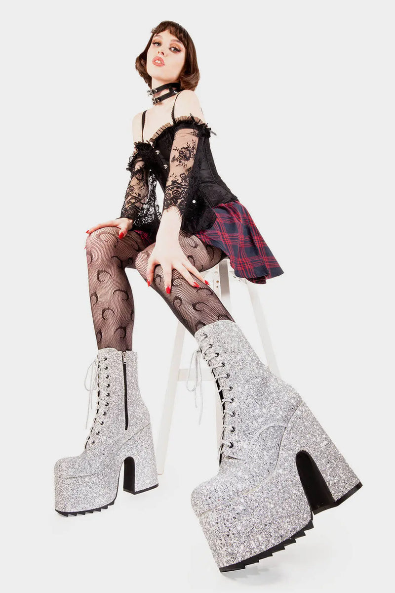 Dazzling Delights
  
  Spotlight Chunky Platform Ankle Creeper Boot in Silver Glitter. These silver vegan Platform Boots feature our iconic glitter detail througout with adjustable lace up detail, shiny perfection to glow with every step. Made with eco-friendly materials and 100% cruelty-free.
  
  
  - Platform Height
  - Heel Height 
  - Black zipper 
  - Silver laces and silver eyelets 
  - Chunky Creeper sole
  - Round Toe
  - 100% vegan 
  
  SKU: LMF 2046 - SilverGlitter
