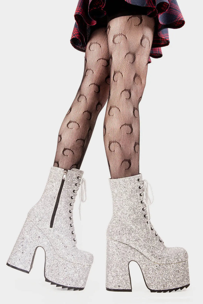 Dazzling Delights
  
  Spotlight Chunky Platform Ankle Creeper Boot in Silver Glitter. These silver vegan Platform Boots feature our iconic glitter detail througout with adjustable lace up detail, shiny perfection to glow with every step. Made with eco-friendly materials and 100% cruelty-free.
  
  
  - Platform Height
  - Heel Height 
  - Black zipper 
  - Silver laces and silver eyelets 
  - Chunky Creeper sole
  - Round Toe
  - 100% vegan 
  
  SKU: LMF 2046 - SilverGlitter