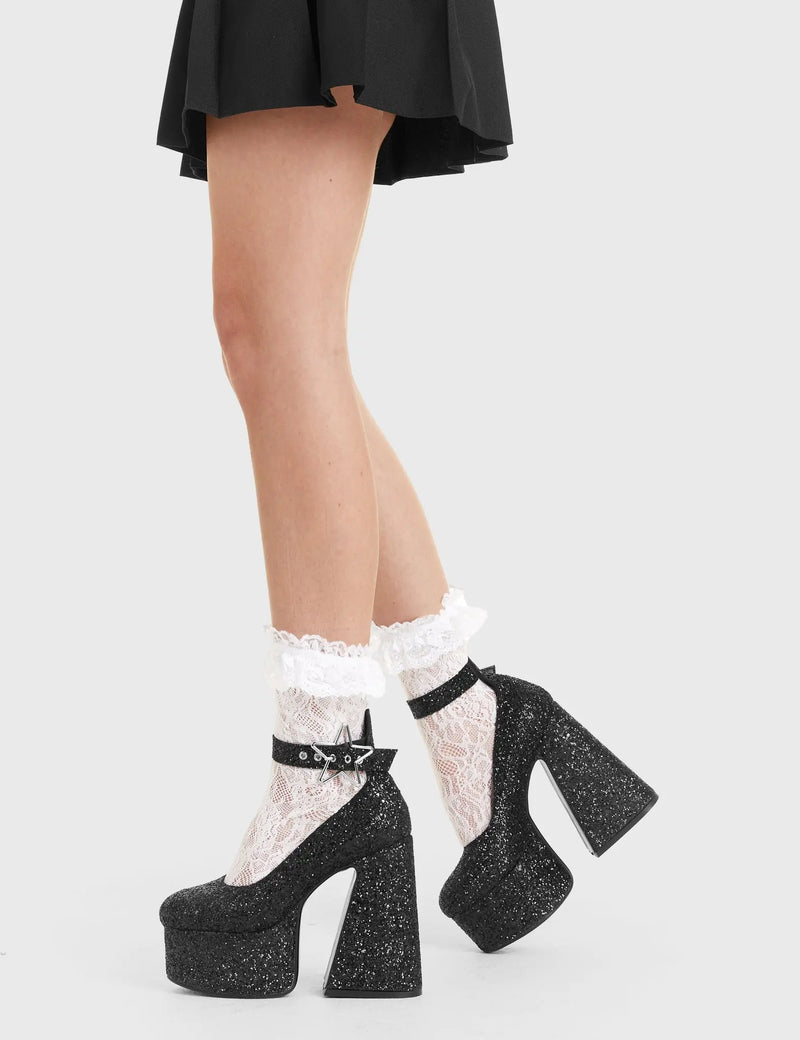 SHINE BRIGHT
  
  Starlight Platform Heels in Black glitter. These platform boots feature a silver star buckle with a flared heel, keeping it nice and classy. Made with eco-friendly materials and 100% cruelty-free, these platform boots are as ethical as they are chic.
  
  - Platform Height
  - Silver Heart buckles
  - Adjustable straps
  - Black Glitter
  - Flared heel
  - High Heel
  - 100% vegan 
  
  SKU: LMF 3348 - BlackGlitter
