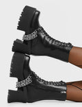FAST LANE Step On It Chunky Platform Ankle Boots in black faux leather. These black vegan Platform Boots feature lace up design with sillver eyelets and two silver aestehtic chains. Also includes a functional zip on our rubber grip, chunky platform sole. Made with eco-friendly materials these platform boots are as ethical as they are perfect! - Platform Height: - Black Zipper - Lace Up Design - Silver Eyelets - Silver Chains - Chunky Platform Sole - 100% vegan SKU: LMF 4118 - BlackPU