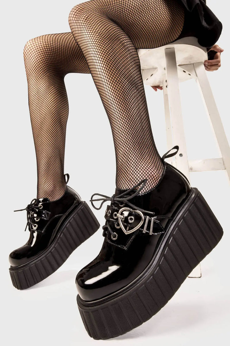 Sweetheart Steps
  
  Stick To It Chunky Platform Creeper Shoes in Black Patent faux leather. These black creeper shoes feature an adjustable black lace up detail with silver eyelets and a adjustable black strap across the upper with heart shaped buckle, leaving a trail of love with every step.
  
  - Platform Height
  - Black Laces with black eyelets
  - Black strap
  - Heart shaped buckle
  - Chunky creeper wedge sole
  - Round Toe 
  - 100% vegan