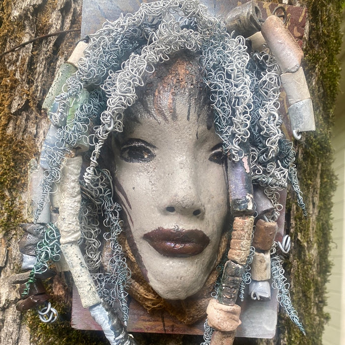 Summer has a white complexion and ruby red lips! She is 6”x 8”" and weighs 2.1 lbs. Summer has over 30 handmade raku fired beads. She has over 80 feet of coiled 16 and 24 gauge wire hair.