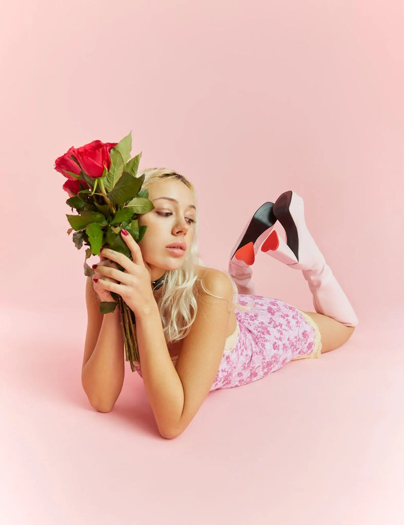 LOVEABLE 
  
  Sweet Talker Platform Knee High Boots in Pink faux leather. These platform boots feature a minimalist look with a heart shaped heel, keeping it nice and classy. Made with eco-friendly materials and 100% cruelty-free, these platform boots are as ethical as they are chic.
  
  - Platform Height
  - Knee length
  - Heart shaped heel
  - Red sole
  - Pink zip
  - High Heel
  - 100% vegan 
  
  SKU: LMF 3313 - PinkPU