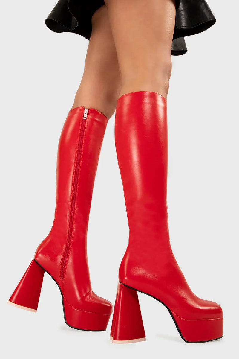 LOVEABLE 
  
  Sweet Talker Platform Knee High Boots in Red faux leather. These platform boots feature a minimalist look with a heart shaped heel, keeping it nice and classy. Made with eco-friendly materials and 100% cruelty-free, these platform boots are as ethical as they are chic.
  
  - Platform Height
  - Knee length
  - Heart shaped heel
  - Pink sole
  - Red zip
  - High Heel
  - 100% vegan 
  
  SKU: LMF 3313 - RedPU