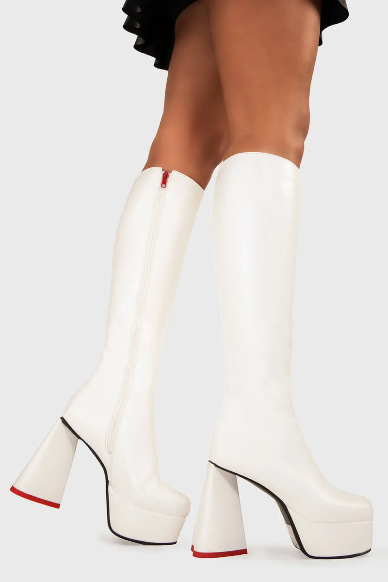 LOVEABLE 
  
  Sweet Talker Platform Knee High Boots in White faux leather. These platform boots feature a minimalist look with a heart shaped heel, keeping it nice and classy. Made with eco-friendly materials and 100% cruelty-free, these platform boots are as ethical as they are chic.
  
  - Platform Height
  - Knee length
  - Heart shaped heel
  - Red sole
  - White zip
  - High Heel
  - 100% vegan 
  
  SKU: LMF 3313 - WhitePU