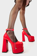 Sweetheart Soles
  
  Sweetheart Platform Heels in Red Patent faux leather. These red vegan Platform Heels feature on our double stack platform sole with a red ankle strap and a heart shaped buckle including a silver chain handing from the ankle strap, setting trends one step at a time. 
  
  
  - Platform Height
  - Heel Height 
  - Heart shaped buckle
  - Red strap with silver eyelets
  - Shark's teeth rubber grip 
  - Chunky platform sole
  - Square Toe
  - 100% vegan 
  
  SKU: LMF 2091 - RedPAT