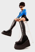 Effortless Edge 
  
  Switching Up Chunky Creeper Platform Knee High Boots in Black faux leather. These black platform boots feature on our chunky platform creeper sole with a stretchy gusset detail, clean lines and sharp looks. Made with eco-friendly materials and 100% cruelty-free.
  
  - Platform Height
  - Black zipper
  - Gusset detail
  - Wide ankle and calf boots
  - Chunky platform creeper wedge sole
  - Round Toe 
  - 100% vegan 
  
  SKU: LMF 2214 - BlackPU