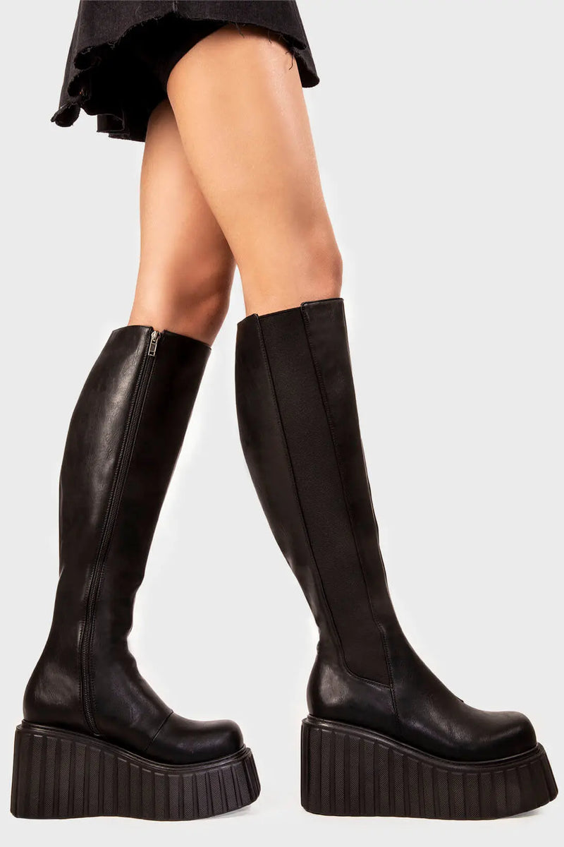 Effortless Edge 
  
  Switching Up Chunky Creeper Platform Knee High Boots in Black faux leather. These black platform boots feature on our chunky platform creeper sole with a stretchy gusset detail, clean lines and sharp looks. Made with eco-friendly materials and 100% cruelty-free.
  
  - Platform Height
  - Black zipper
  - Gusset detail
  - Wide ankle and calf boots
  - Chunky platform creeper wedge sole
  - Round Toe 
  - 100% vegan 
  
  SKU: LMF 2214 - BlackPU