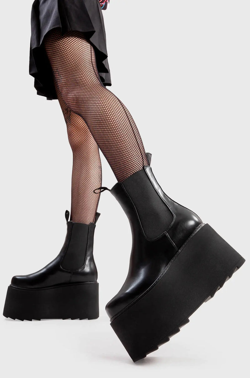 Step Out in Fashion
  
  Time Waster Chunky Platform Ankle Boots in Black faux leather. These flatform shoes feature a minimalist design, with a gusset and two pull tags. Made with eco-friendly materials and 100% cruelty-free, these platform boots are as ethical as they are Edgy
  
  - Platform Height
  - Gusset
  - Two pull tags
  - Flatform Sole
  - Shark's Teeth Grip
  - 100% vegan 
  
  SKU: LMF 3138 - BlackPU