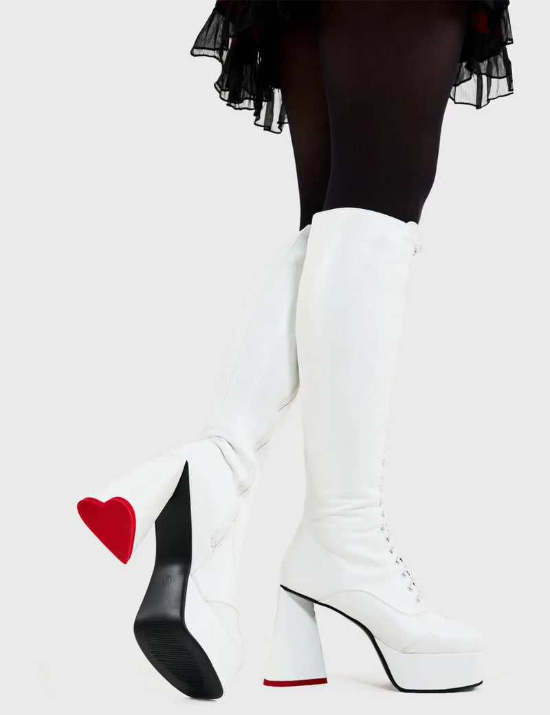 SO IN LOVE
  
  Too Cute Platform Knee High Boots in White faux leather. These platform boots feature a minimalist look with a heart shaped heel, keeping it nice and classy. Made with eco-friendly materials and 100% cruelty-free, these platform boots are as ethical as they are chic.
  
  - Platform Height
  - Knee length
  - Heart shaped heel
  - Lace up
  - Red sole
  - White zip
  - High Heel
  - 100% vegan 
  
  SKU: LMF 3314 - WhitePU