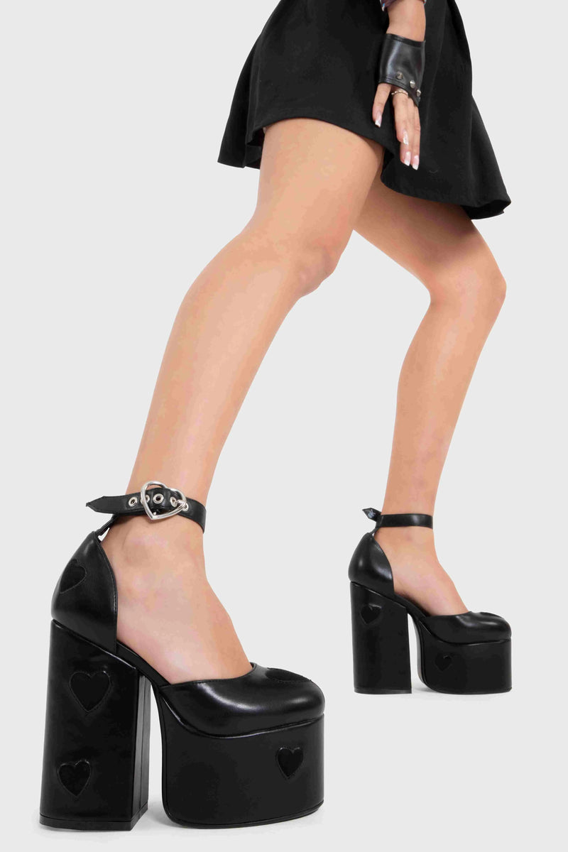 CHAINED UP
  
  Translate Love Platform Heels in Black faux leather. These vegan heels feature a sliver heart buckle and silver eyelets. Also features black suede hearts throughout the heels. Made with eco-friendly materials and 100% cruelty-free, these heels are as ethical as they are trendy. 100% vegan
  
  - Heel Height
  - Ankle length
  - Adjustable Strap
  - Silver Heart Buckle
  - Sliver Eyelets
  - Platform Sole
  - Black Suede Hearts
  - 100% vegan
  
  SKU: LMF 2385 - BlackPU/SuedeHeart