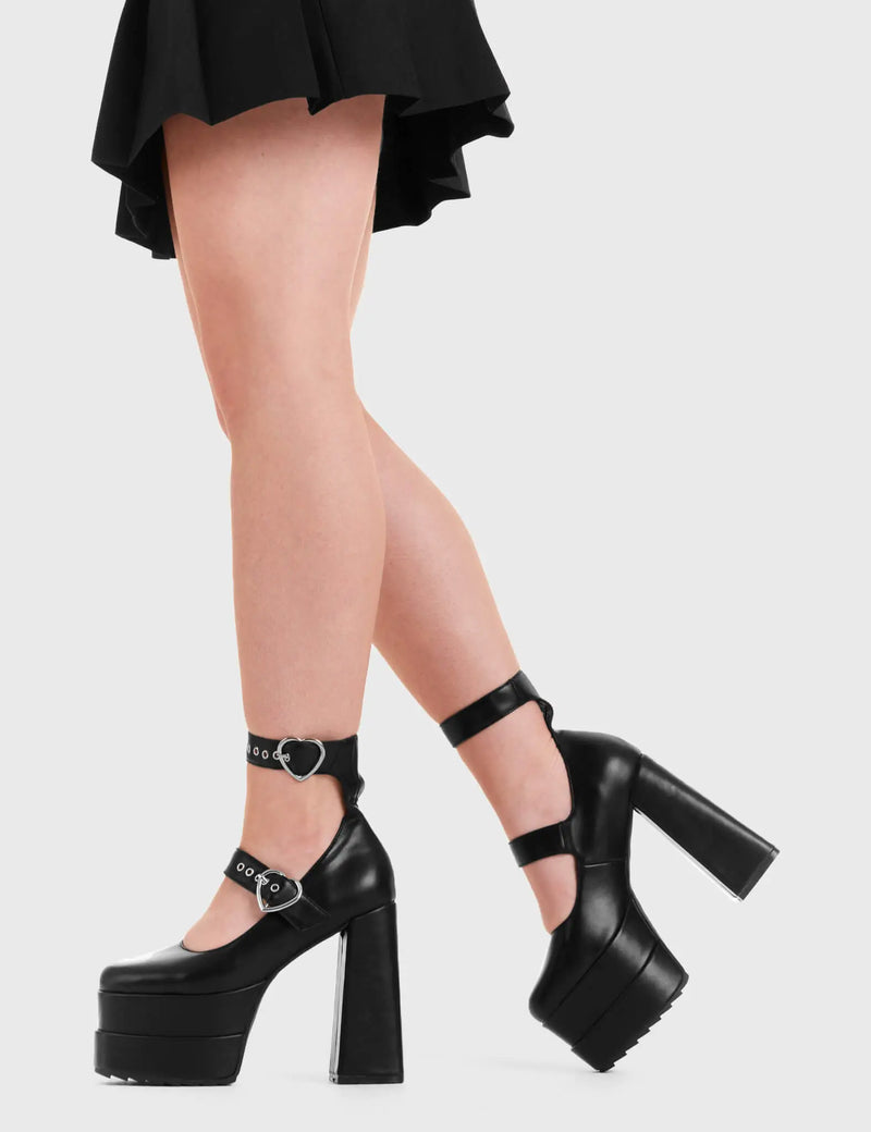 THE HEELS OF YOUR LIFE 
  
  Two Timing Platform Heels in Black faux leather. These platform boots feature two adjustable straps with heart shaped buckles, keeping it nice and classy. Made with eco-friendly materials and 100% cruelty-free, these platform boots are as ethical as they are chic.
  
  - Platform Height
  - Silver heart buckles
  - Two adjustable straps
  - Silver eyelets
  - Shark teeth grip
  - High Heel
  - 100% vegan 
  
  SKU: LMF 3315 - BlackPU