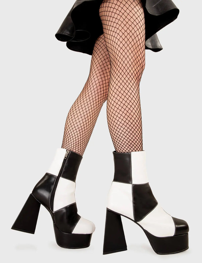 TIME TO DANCE
  
  Wait A Minute Platform Ankle Boots in Black and white faux leather. These platform boots feature a black and white patch work design with a triangle heel, keeping it nice and classy. Made with eco-friendly materials and 100% cruelty-free, these platform boots are as ethical as they are chic.
  
  - Platform Height
  - Ankle length
  - Patch work design
  - Triangle heel
  - High Heel
  - 100% vegan 
  
  SKU: LMF 3330 - BlackPU/WhitePU