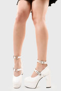 Elevated Ego.
  
  Walk With Faith Platform Heels in White faux leather. These vegan Platform Heels feature two adjustable white straps with a silver heart in the center and silver eyelets, turning heads with every step. Made with eco-friendly materials and 100% cruelty-free, these Boots are as ethical as they are fierce!
  
  - Platform Height: 1.25 inch
  - Heel Height: 4.2 inch
  - Two adjustable straps
  - Silver heart detail
  - Platform sole
  - Round toe
  - 100% vegan
  
  SKU: LMF 1556 - WhitePU