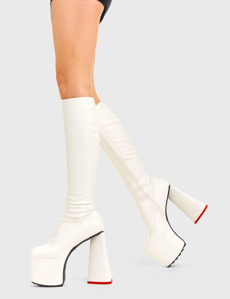 PEACE AND LOVE
  
  Wild Child Platform Knee High Boots in White Fitted Faux Leather. These vegan western Boots feature heart shaped heel, with a red sole and shark teeth grips, very classy. Made with eco-friendly materials and 100% cruelty-free, these boots are as ethical as they are edgy!
  
  
  - Chunky Platform heels
  - Knee length
  - Shark teeth grip
  - Fitted feel
  - Heart shaped heel
  - Red heel sole
  - Rounded toe 
  - 100% vegan 
  
  SKU: LMF 3633 - BlackStretchPU