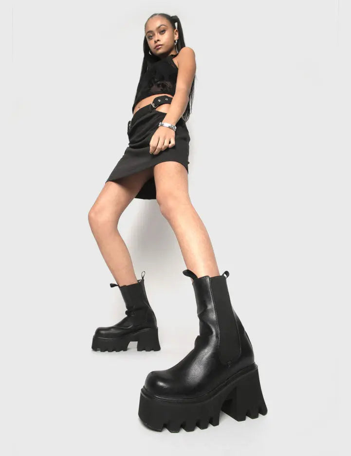 COMFY AND CHUNKY Wipe Out Chunky Platform Ankle Boots in Black faux leather. These vegan Ankle Boots feature an elastic gusset and a chunky platform sole, making them the perfect comfy Boots for any occasion. Made with eco-friendly materials and 100% cruelty-free, these boots are as ethical as they are stylish! - Platform Height: 3.3 inch - Wide ankle friendly - Wide calf friendly - High ankle height - Black elastic gusset - Black pull tab - Chunky Platform sole - 100% vegan SKU: LMF 1086 - BlackPU