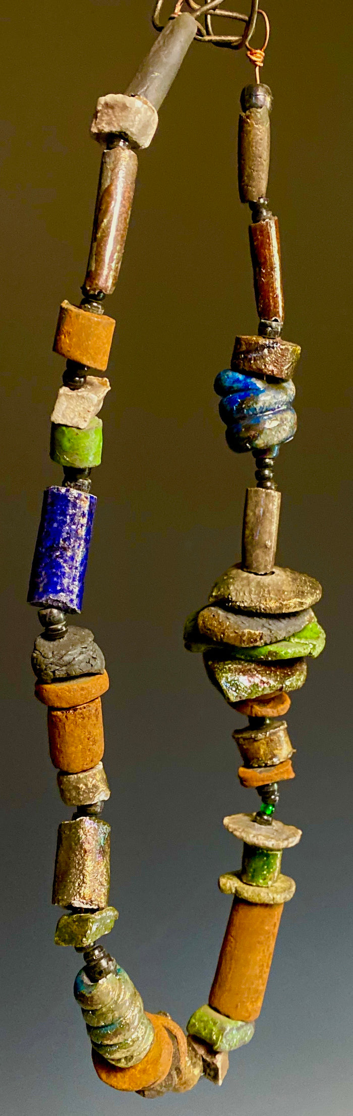This one is really nice! 22” long 12" vertical drop  over 35 multi colored raku beads Tribal!